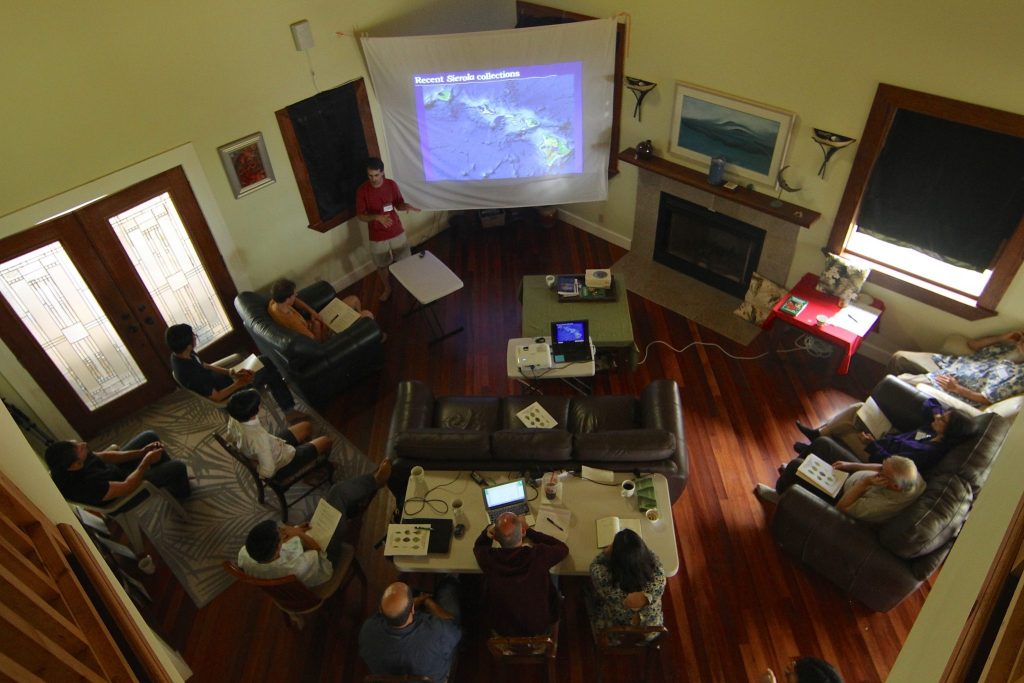 scientists listening to a presentation in the living room