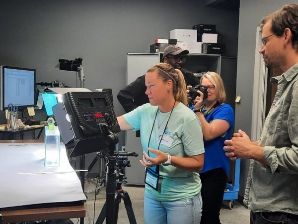 Scientist and Imaging Lab Manager, Zachary Randall, works with teachers to photograph fish specimens.