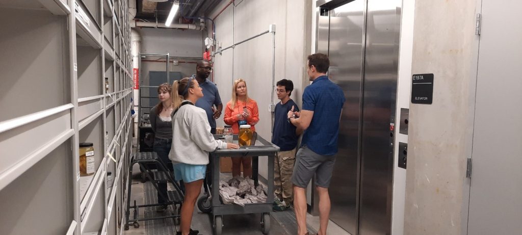 Teachers speak with Ichthyology Collections Manager Rob Robbins and staff members Nicholas Mauro and Sydney Stanley.