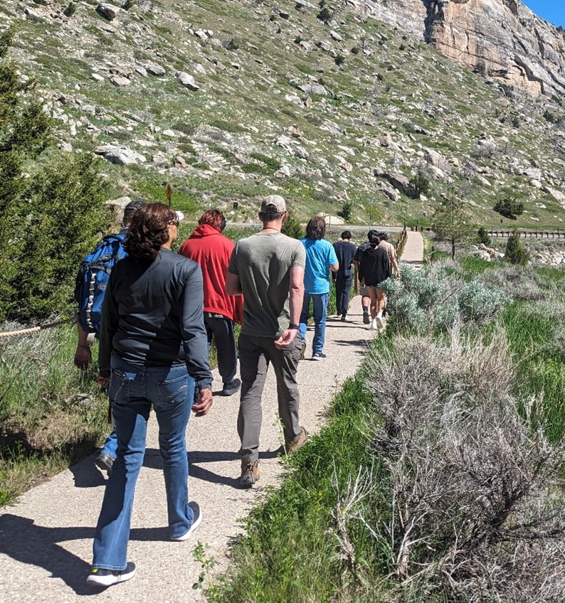 Fig 3: Students at Sinks Canyon following a guide while learning about the geology of the canyon.