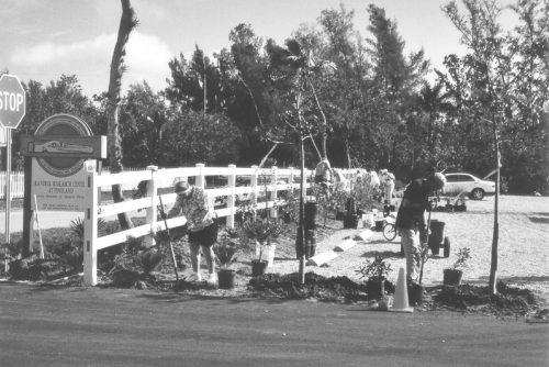 people planting near the RRC sign