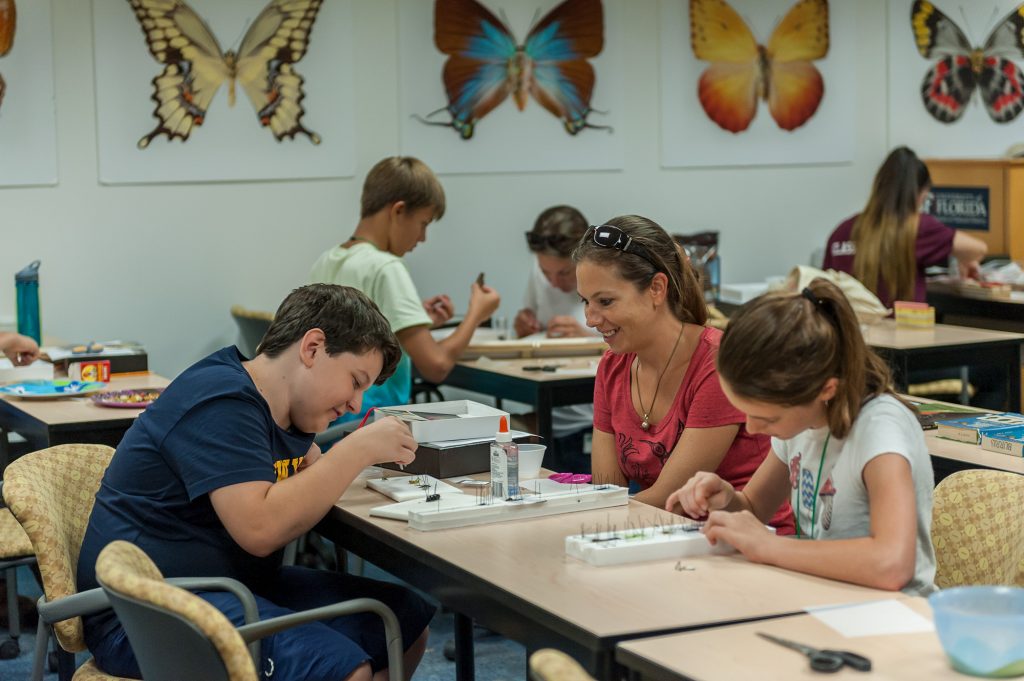 teachers and students working at long tables