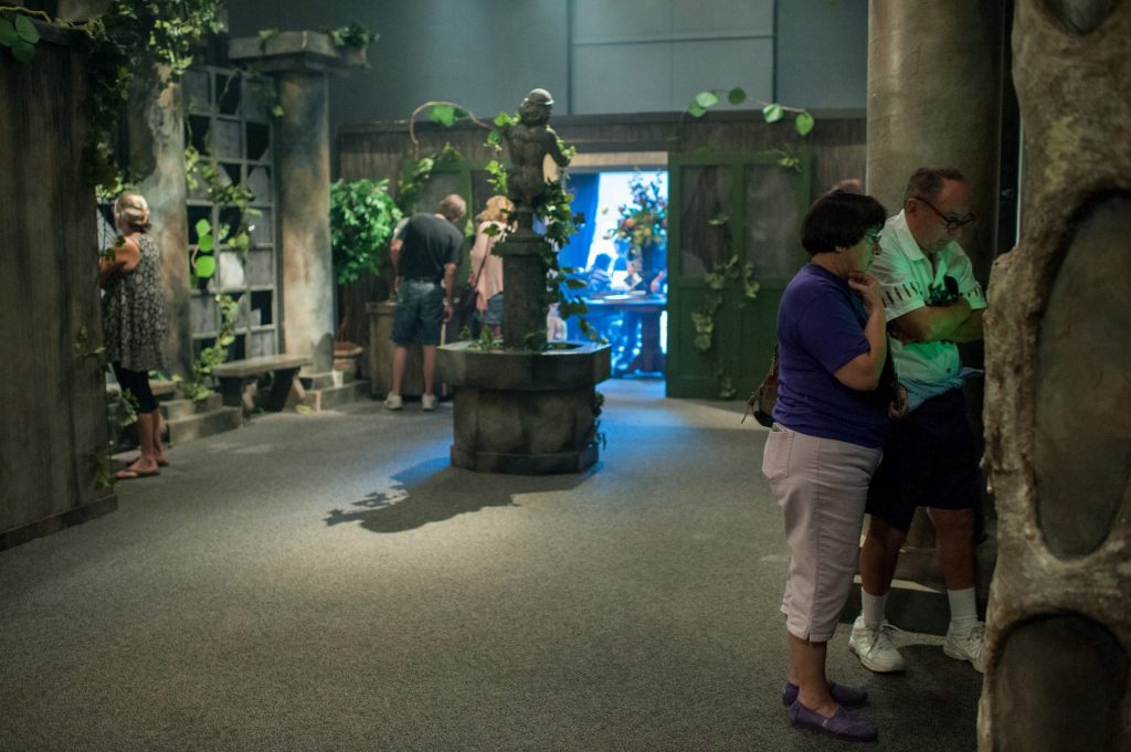 people looking at several displays in the wicked plants exhibit