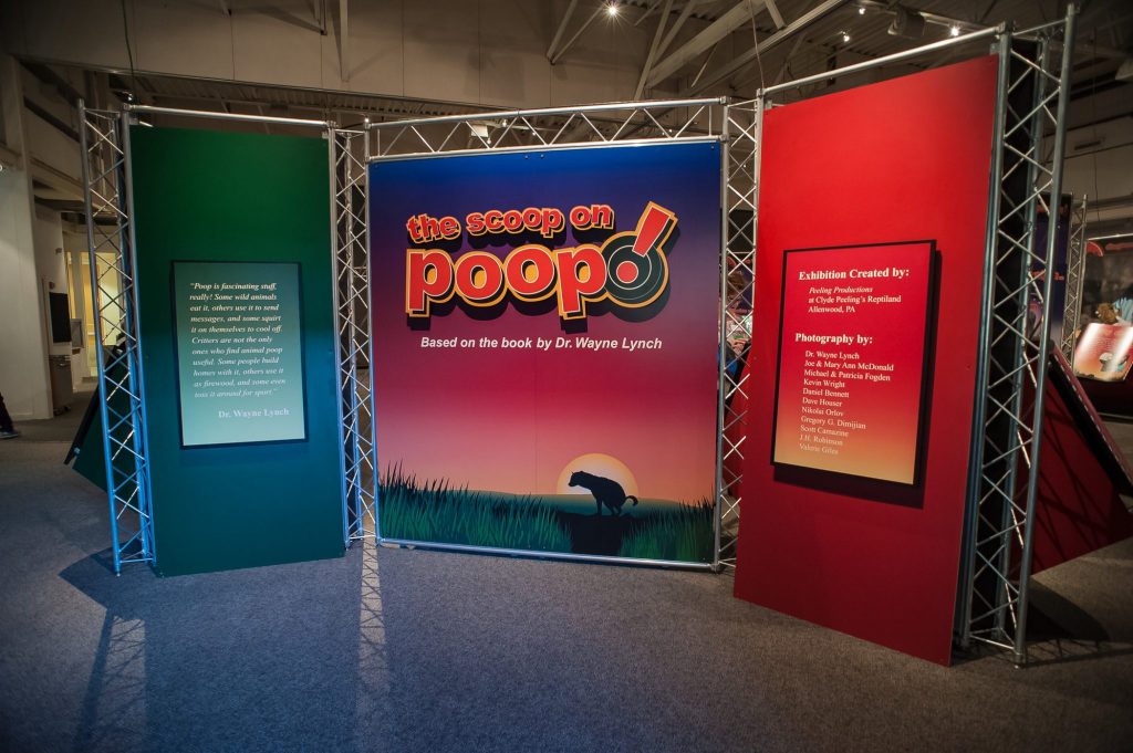 display wall for the scoop on Poop! with text about the exhibit and the exhibit logo