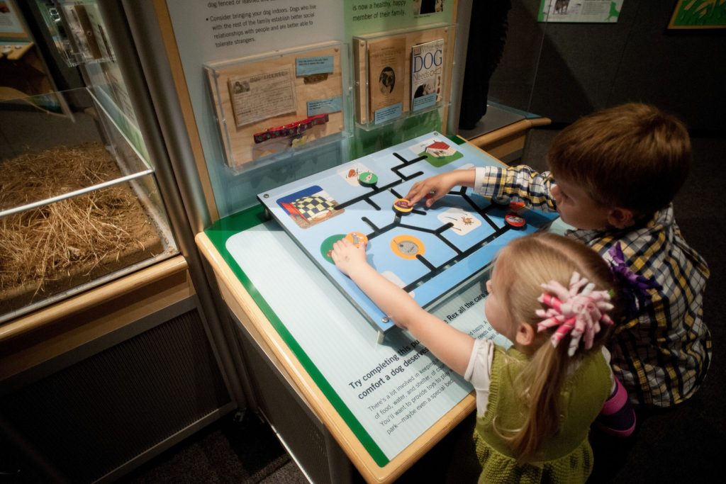 children play with interactive exhibit