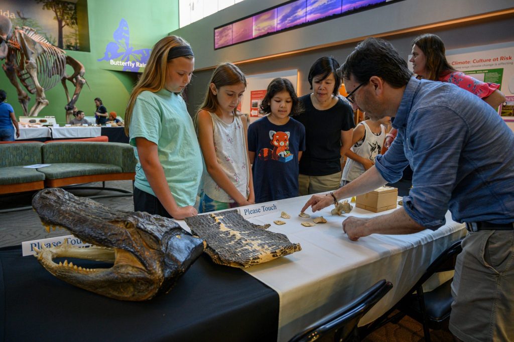 researcher speaking to museum visitors