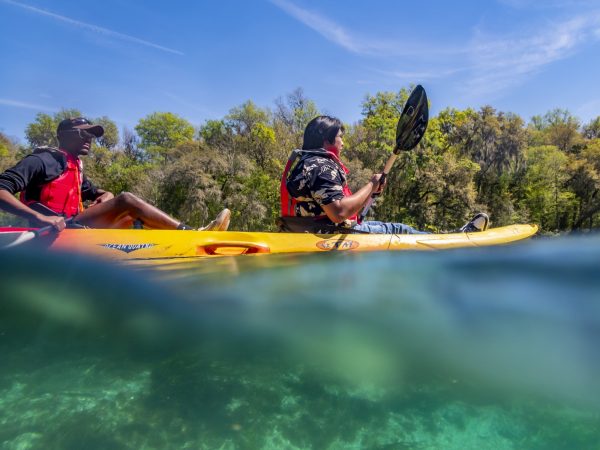 Two people sit on a two person kayak