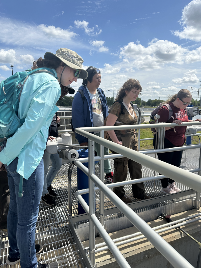 Fellows peer into holding tanks at the Ocala Water Reclamation Facility.