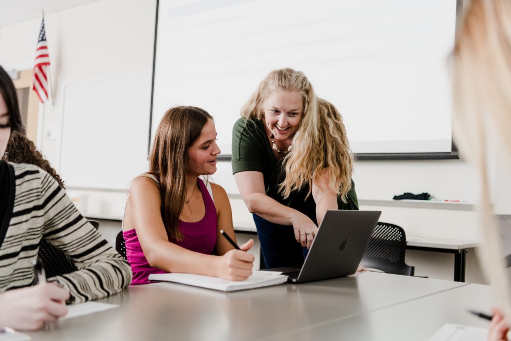 Student and professor in classroom.