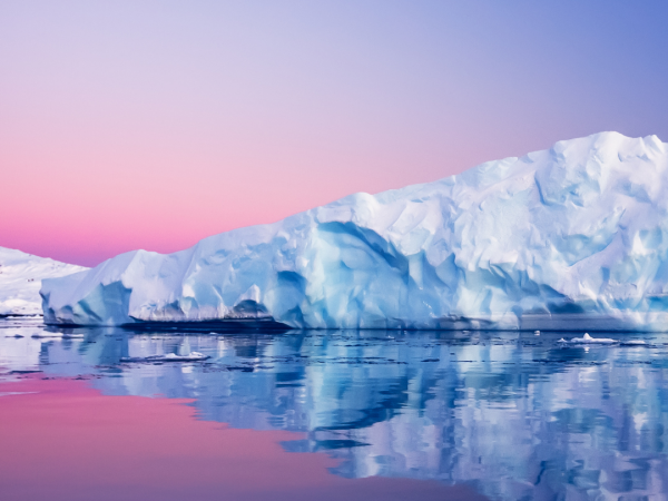 pink and purple gradient sunset behind a white floating glacier.